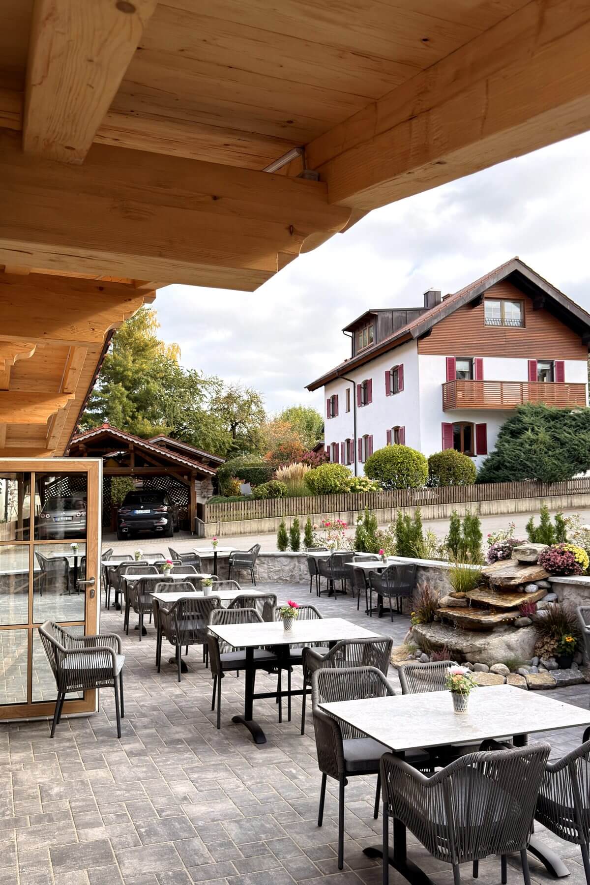 Hochformat der Terrasse im Restaurant Pfeiffer am Wörthsee mit Outdoor-Stühlen und Blick auf den Außenbereich