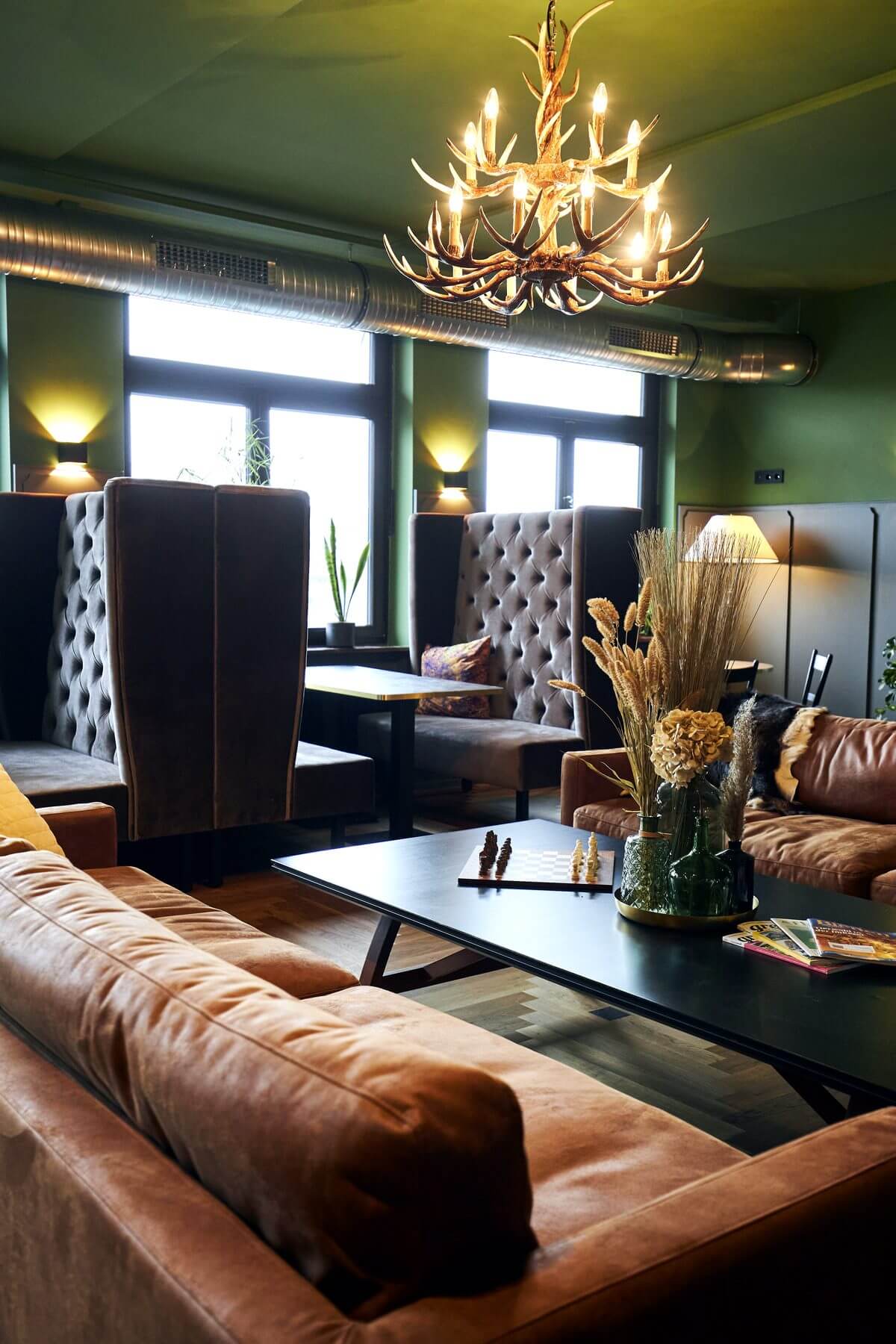 Hochformataufnahme des Loungebereichs bei ERCK Bad Schönborn mit Sofa und Banksystem