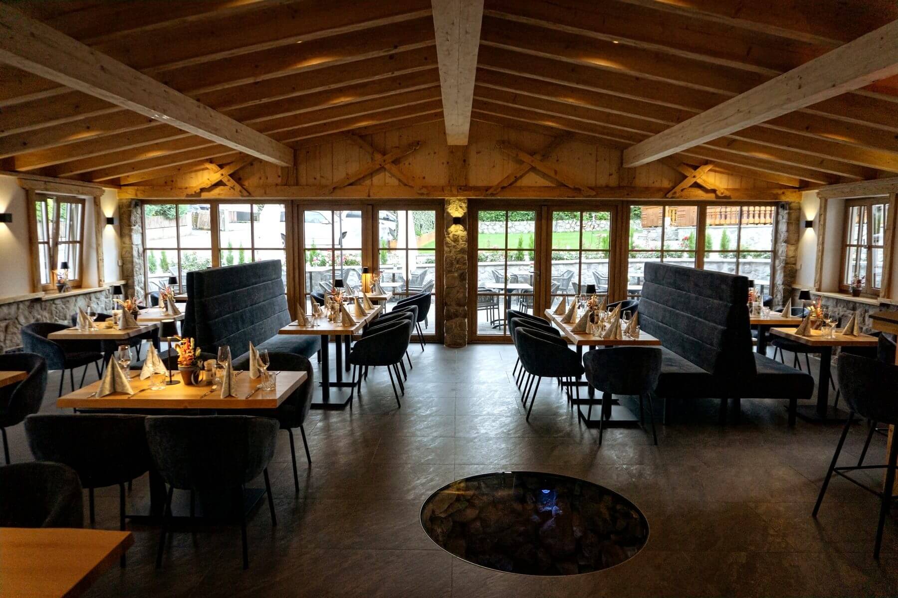 Innenbereich des Restaurant Pfeiffer am Wörthsee mit Polsterbänken, Tischen und großen Fenstern